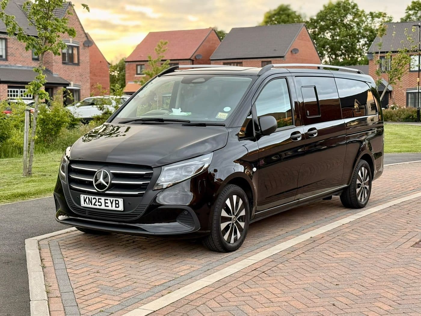A City Wheels Mercedes Vito Tourer parked outside a home at sunset
