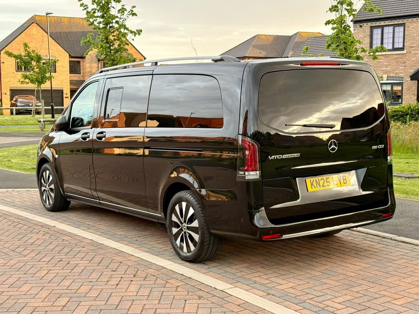 A City Wheels Mercedes Vito Tourer parked outside a home at sunset