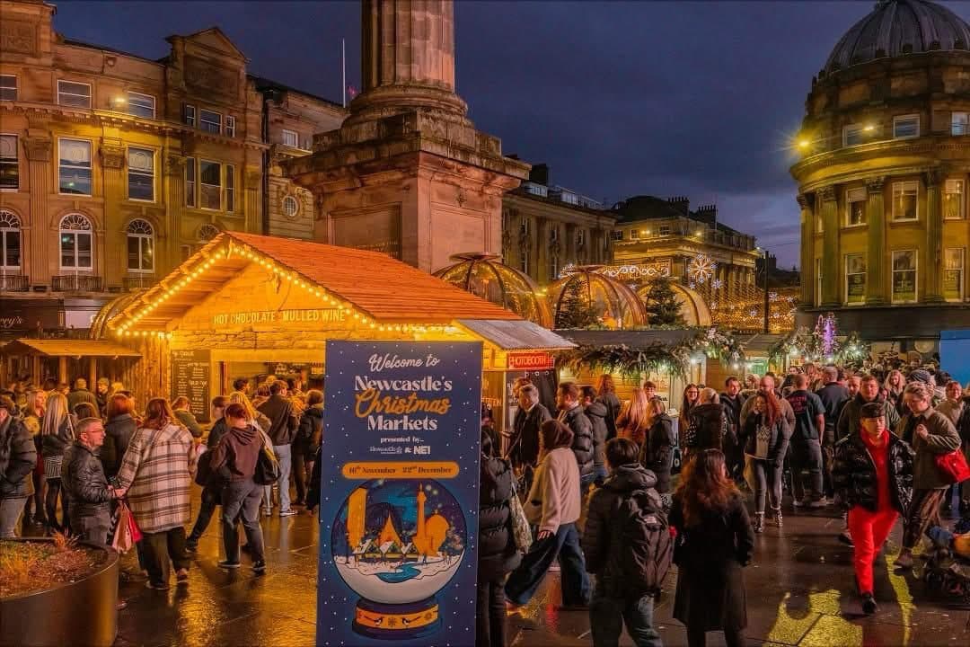 A busy UK Christmas market at night